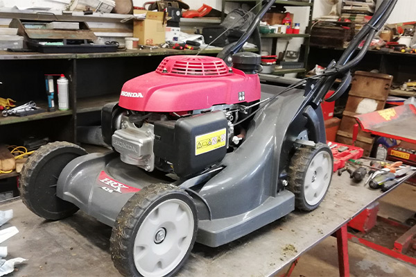 Lawn mower being fixed in the workshop at Clifton's Turf Machiner