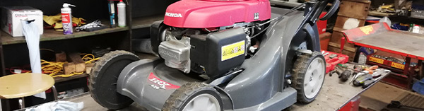 Lawn mower being fixed in the workshop at Clifton's Turf Machiner